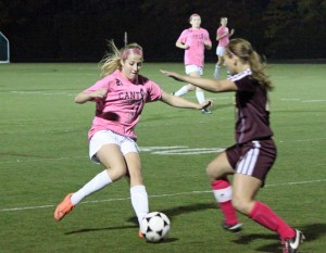 Senior Sammy Sullivan (left) battles a Sharon player for possession. (Mike Barruci photo)